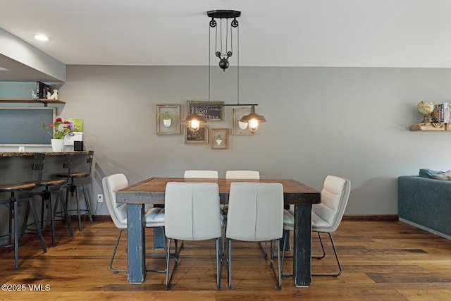 dining area with wood finished floors, baseboards, and recessed lighting