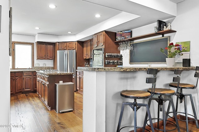 961 June Creek Rd, Edwards, CO 81632 - kitchen featuring open shelves, stainless steel appliances, a peninsula, a breakfast bar, and plenty of natural light