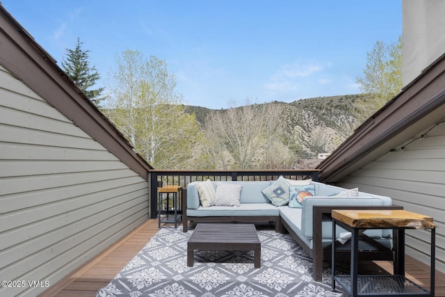 wooden deck featuring an outdoor hangout area and a mountain view