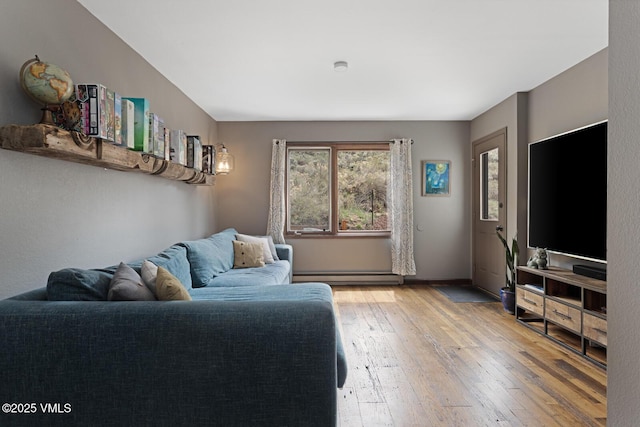 living area with baseboard heating and light wood-type flooring