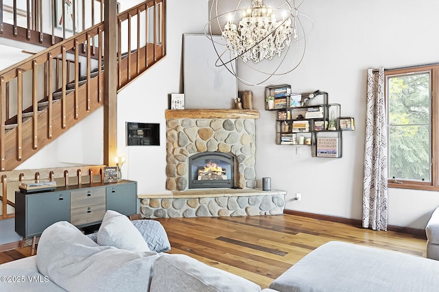961 June Creek Rd, Edwards, CO 81632 - living room featuring wood finished floors, a chandelier, stairway, and a stone fireplace