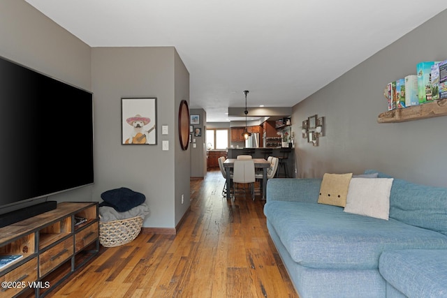living room with wood finished floors and baseboards