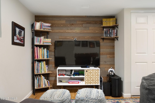 living area featuring wood finished floors and baseboards