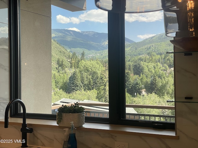 42 Riverfront Ln Unit 304, Avon, CO 81620 - kitchen view of a heavily wooded area and mountains