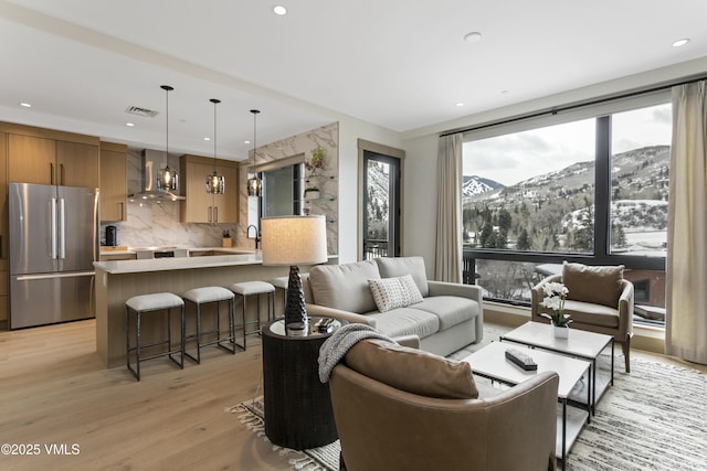42 Riverfront Ln Unit 304, Avon, CO 81620 - living area featuring a mountain view, light wood finished floors, and recessed lighting