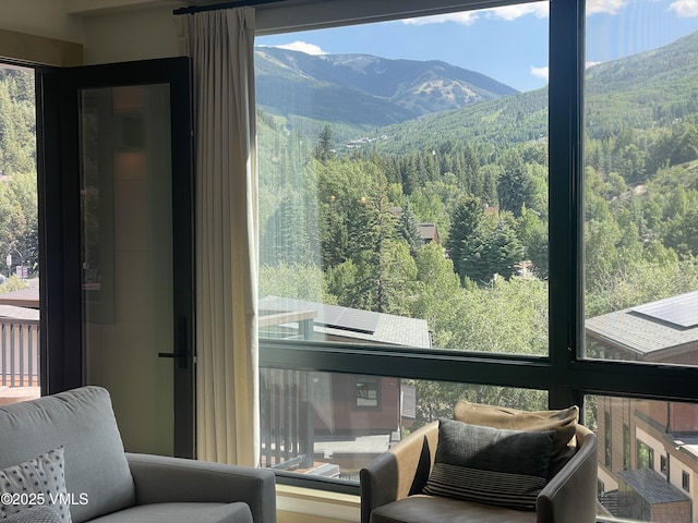 42 Riverfront Ln Unit 304, Avon, CO 81620 - sunroom / solarium featuring a mountain view, healthy amount of natural light, and a view of trees