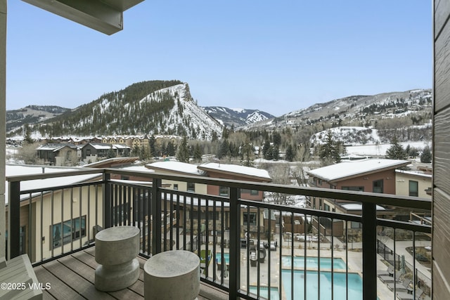 42 Riverfront Ln Unit 304, Avon, CO 81620 - snow covered back of property featuring a mountain view and view of pool