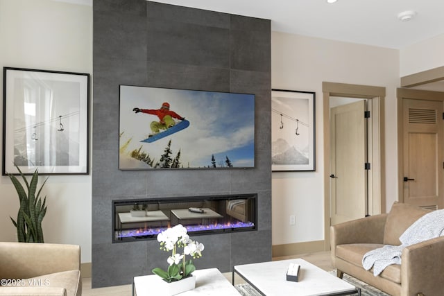 42 Riverfront Ln Unit 304, Avon, CO 81620 - living area featuring a fireplace and baseboards
