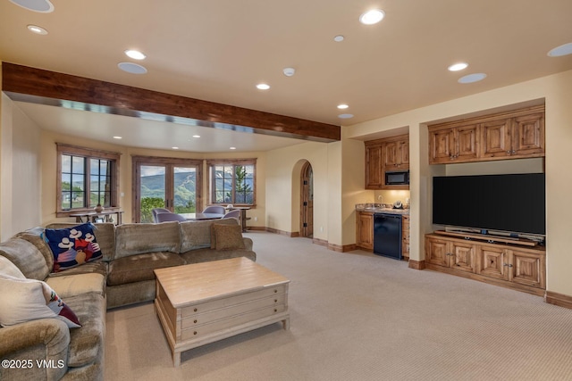 1006 Chiming Bells, Avon, CO 81620 - living room featuring arched walkways, recessed lighting, beam ceiling, light colored carpet, and bar