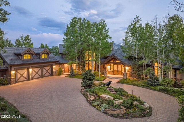 1006 Chiming Bells, Avon, CO 81620 - tudor home with stone siding, decorative driveway, a garage, and covered porch