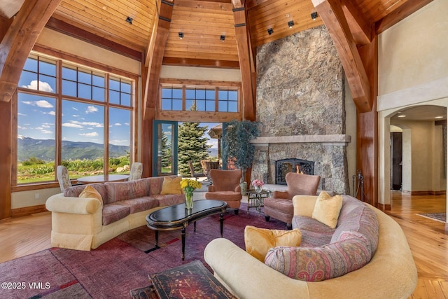 1006 Chiming Bells, Avon, CO 81620 - living room with a towering ceiling, a mountain view, arched walkways, wood-type flooring, and a fireplace