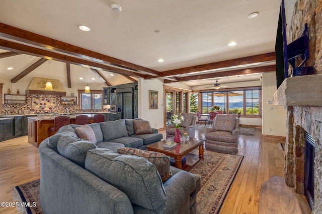 1006 Chiming Bells, Avon, CO 81620 - living area with a stone fireplace, recessed lighting, beam ceiling, light wood-style flooring, and a ceiling fan