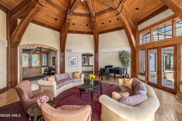 1006 Chiming Bells, Avon, CO 81620 - living room with french doors, high vaulted ceiling, arched walkways, light wood-type flooring, and a wooden ceiling with exposed beams