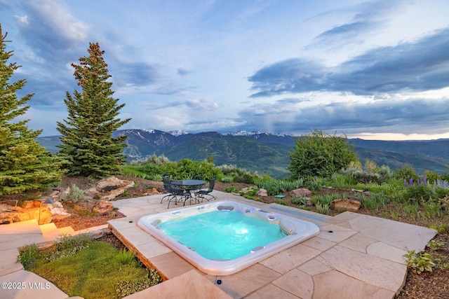 1006 Chiming Bells, Avon, CO 81620 - view of swimming pool featuring a mountain view, an outdoor hot tub, a patio area, and outdoor dining area