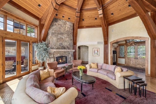 1006 Chiming Bells, Avon, CO 81620 - living area with french doors, arched walkways, high vaulted ceiling, a wood ceiling with exposed beams, and a fireplace