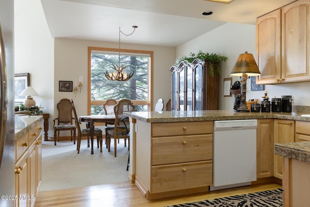 kitchen with dishwasher, light brown cabinets, tile counters, and a peninsula