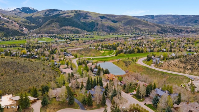 aerial view of property's location featuring a water and mountain view
