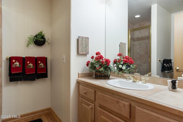 full bathroom with a shower stall and vanity