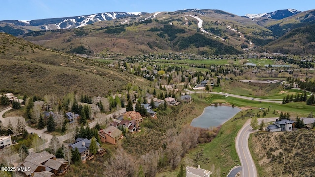 aerial view of property and surrounding area with a water and mountain view