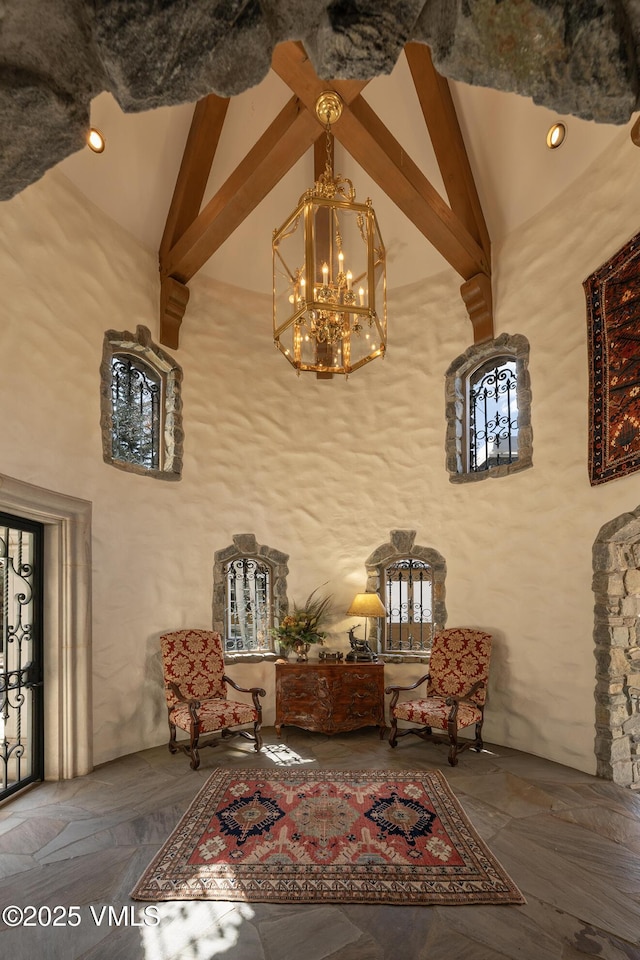 443 Beaver Dam Rd, Vail, CO 81657 - living area with beamed ceiling, high vaulted ceiling, and a chandelier