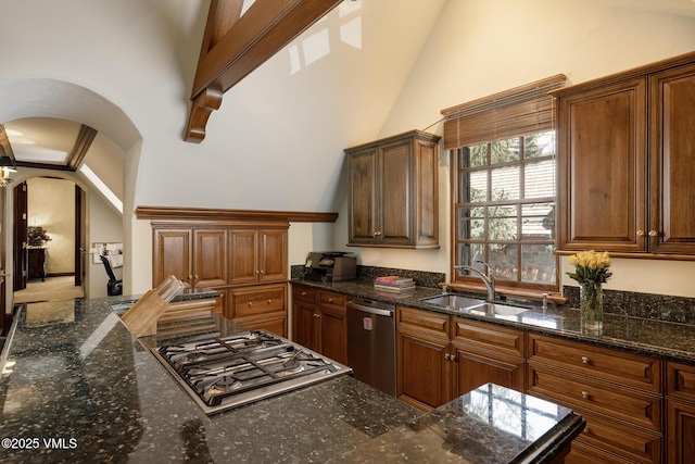 443 Beaver Dam Rd, Vail, CO 81657 - kitchen featuring appliances with stainless steel finishes, high vaulted ceiling, dark stone countertops, and arched walkways