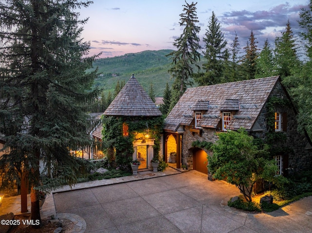 443 Beaver Dam Rd, Vail, CO 81657 - view of front of property featuring stone siding, driveway, and a garage