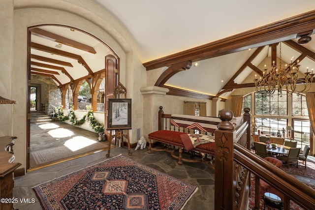 443 Beaver Dam Rd, Vail, CO 81657 - foyer with a chandelier, stone flooring, beam ceiling, high vaulted ceiling, and decorative columns