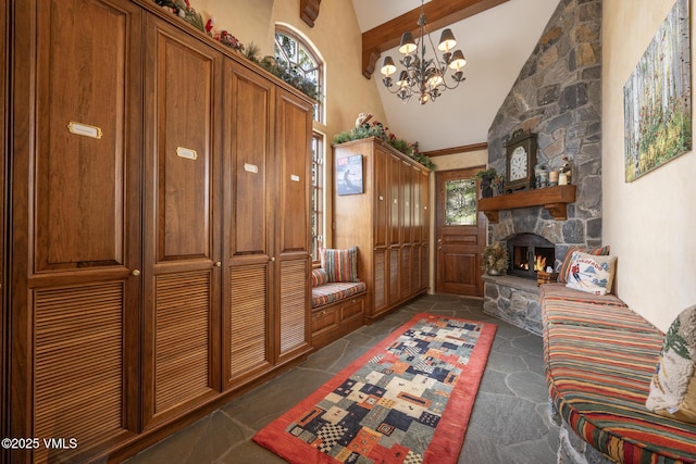 443 Beaver Dam Rd, Vail, CO 81657 - mudroom with high vaulted ceiling, beamed ceiling, a chandelier, dark stone finish flooring, and a fireplace