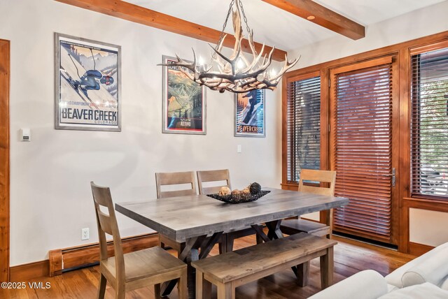 205 Bear Paw Unit B102, Avon, CO 81620 - dining room with wood finished floors, baseboards, beam ceiling, and a chandelier