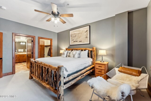 205 Bear Paw Unit B102, Avon, CO 81620 - bedroom with connected bathroom, a ceiling fan, baseboards, and light carpet