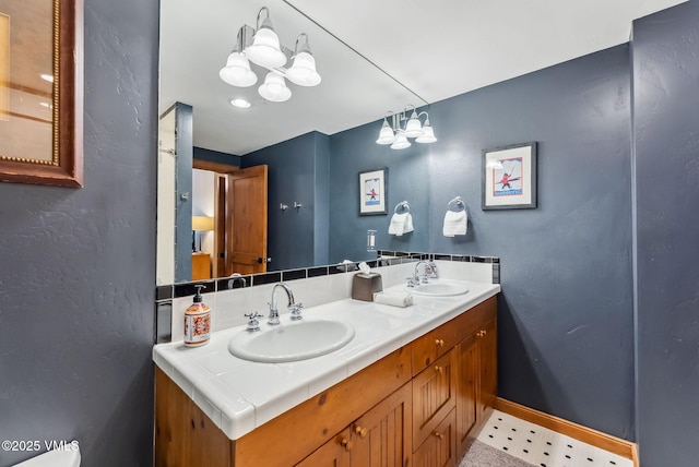 205 Bear Paw Unit B102, Avon, CO 81620 - bathroom featuring double vanity, a sink, and baseboards