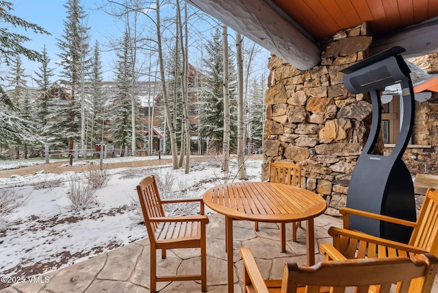 205 Bear Paw Unit B102, Avon, CO 81620 - snow covered back of property with a patio