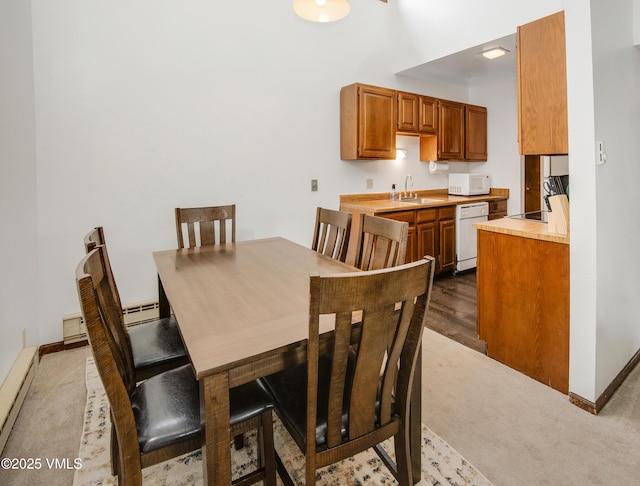 1061 W Beaver Creek Blvd Unit Q302, Avon, CO 81620 - dining area featuring a baseboard radiator, dark carpet, baseboards, and a high ceiling