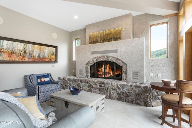 living room featuring light carpet, a stone fireplace, and a wealth of natural light