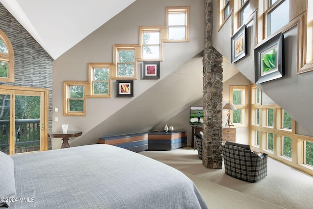 bedroom featuring carpet floors and high vaulted ceiling