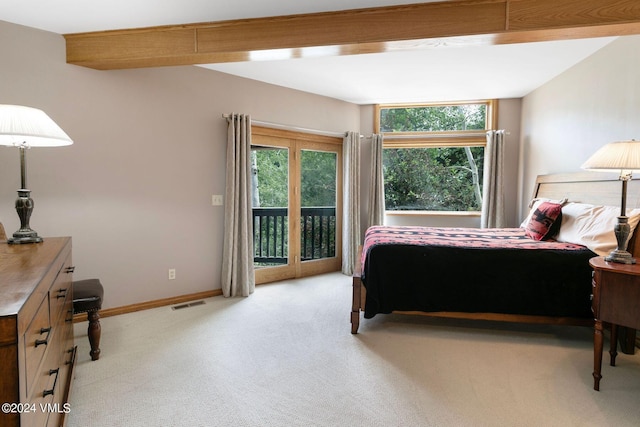 bedroom with access to outside and light colored carpet