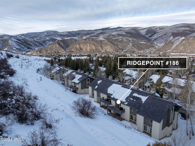 snowy aerial view featuring a mountain view