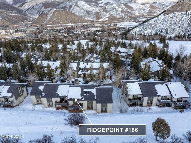 snowy aerial view featuring a mountain view