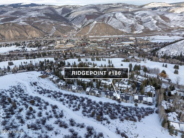 snowy aerial view with a mountain view