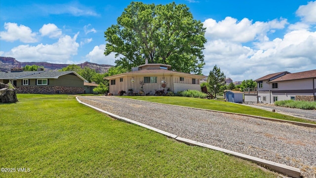 541 20 1/2 Rd, Grand Junction, CO 81505 - view of front of house with a mountain view, a front yard, and gravel driveway