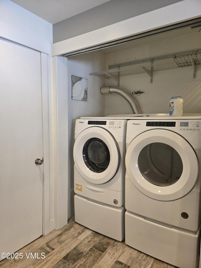 laundry area featuring hardwood / wood-style flooring and washer and clothes dryer