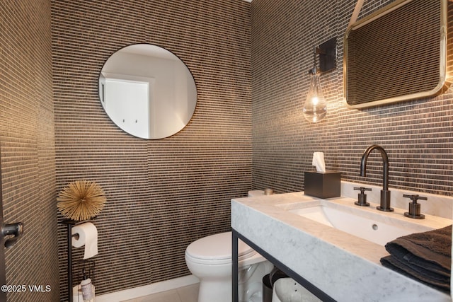 114 Mission Pl, Edwards, CO 81632 - bathroom with tile walls, sink, tile patterned floors, and toilet