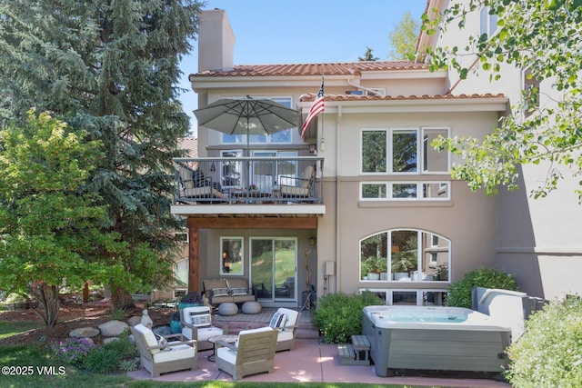 114 Mission Pl, Edwards, CO 81632 - back of house featuring a patio area, central air condition unit, a balcony, a hot tub, and outdoor lounge area
