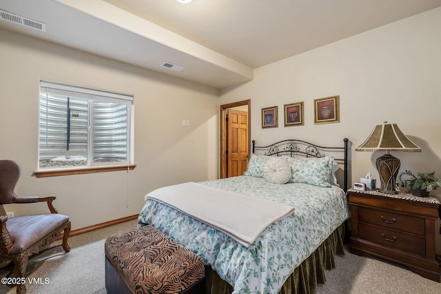 bedroom with carpet, visible vents, and baseboards