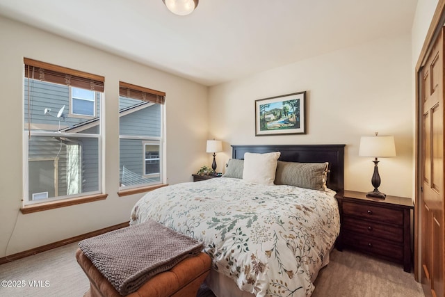 carpeted bedroom featuring baseboards