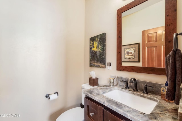 bathroom with toilet and vanity