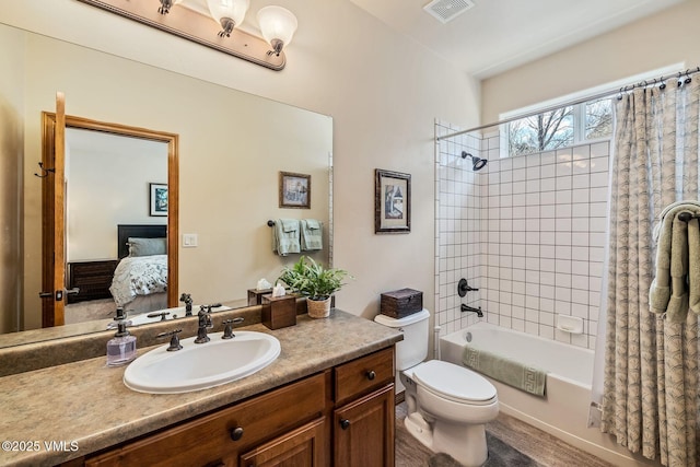 ensuite bathroom featuring visible vents, connected bathroom, toilet, shower / tub combo with curtain, and vanity