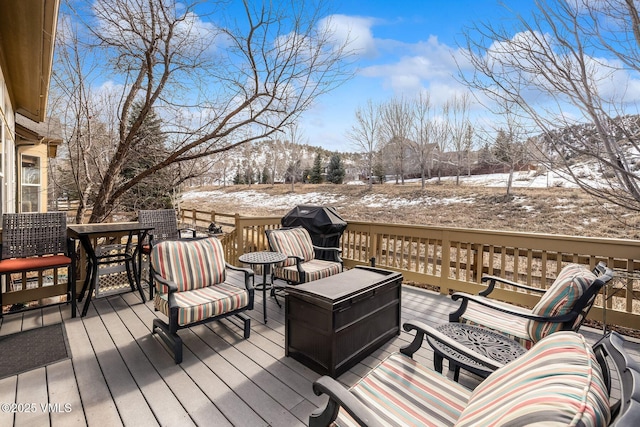 snow covered deck with area for grilling and outdoor lounge area