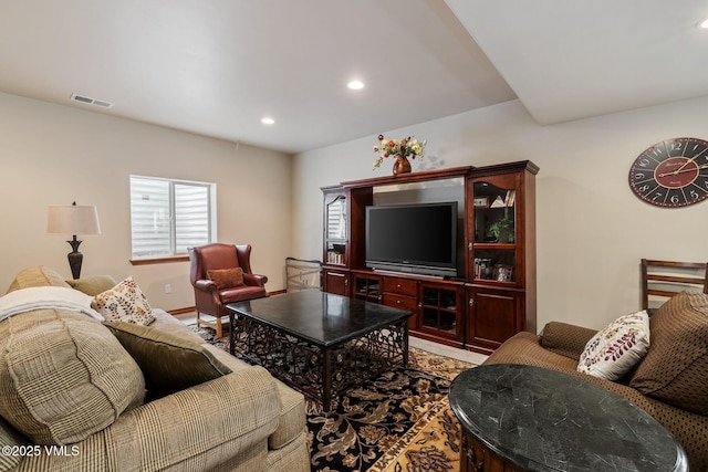 living room featuring baseboards, visible vents, and recessed lighting