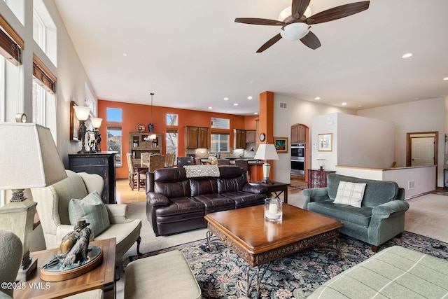 living room featuring light colored carpet, recessed lighting, and a healthy amount of sunlight